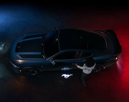 2024 Ford Mustang® Dark Horse™ model with a driver approaching the vehicle | LUV Ford in Henryetta OK