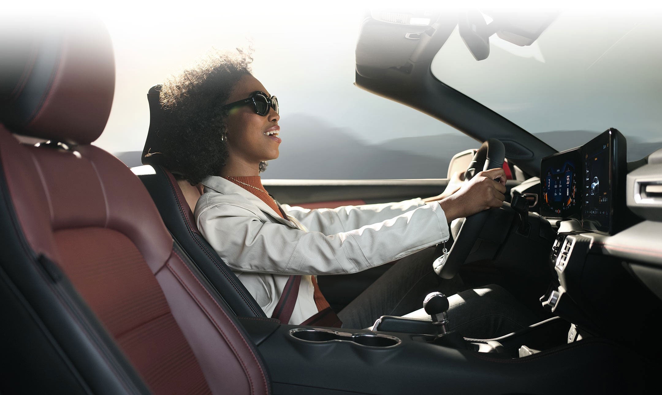 Person sitting in the driver’s seat of a 2024 Ford Mustang® convertible | LUV Ford in Henryetta OK